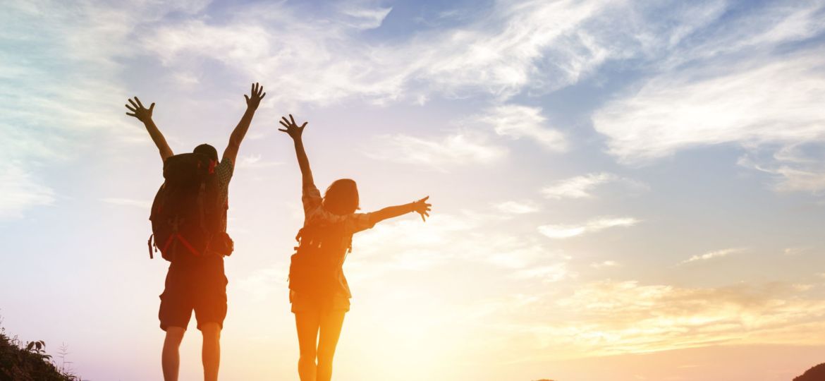 Two,Happy,Tourists,Backpackers,Greetings,Sunrise,Or,At,Mountains,Top